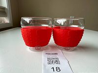 Front view of both Bodum glasses with red sleeves