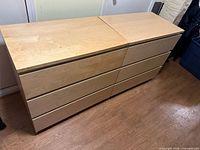 Two birch Ikea Malm dressers side by side showing fronts and tops