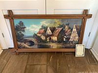 Full view of framed oil painting with certificate