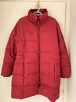 Front view of red Columbia puffer coat showing zipper, collar, pockets