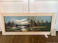 Full view of framed oil landscape painting with COA card
