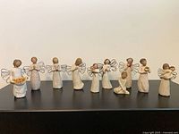 All ten Willow Tree figurines lined up on shelf