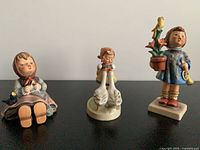 All three Goebel Hummel figurines on display