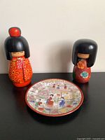 Group shot of both Kokeshi dolls and plate