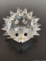 Front view of faceted crystal hedgehog showing eyes, nose, whiskers, spikes