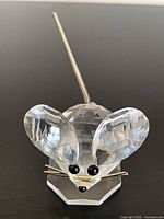 Front view of Swarovski crystal mouse showing faceted body, ears, eyes, whiskers, tail and base
