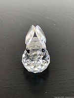 Front view of faceted crystal rabbit figurine showing eyes and ears