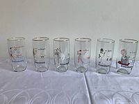 All six Kronenbourg glasses lined up showing unique country designs