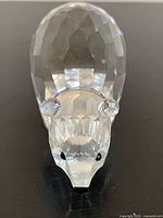 Front view of Swarovski crystal polar bear showing faceted head with ears and black eyes