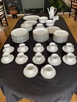 Full set laid out on table showing all place settings and serving pieces