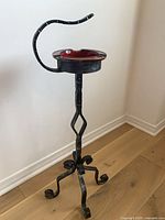 Full view of wrought iron standing ashtray showing overall form and height