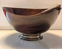 Mahogany bowl on silver-plated base with servers resting inside