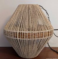 Full view of jute-wrapped pendant lamp showing chain and cord