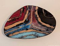 Top view of enamel dish showing abstract multicolour design