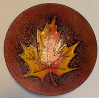 Front view showing maple leaf design and speckled enamel surface