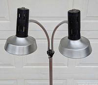 Close view of twin shades and gooseneck arms