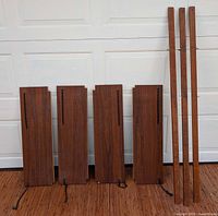 All four shelves and three uprights leaning against garage door