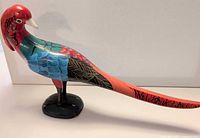 Left side profile of painted wooden pheasant