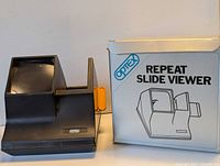 Slide viewer positioned beside original box showing branding and overall design