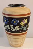 Full front view of vase showing floral band and striped body