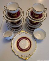 Stacked plates and cups showing quantity and pattern