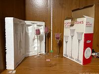 Box, styrofoam insert and three candle holders displayed