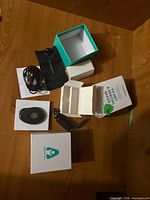 All components laid out: tracker, cable, adapter, pouch, boxes