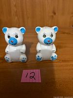 Front view of pair of ceramic bear shakers