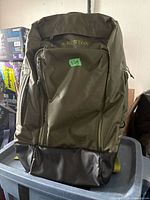 Front view showing Burton logo, main zip compartment, black bottom