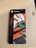Front view of boxed Saker 10" contour gauge with instructions visible