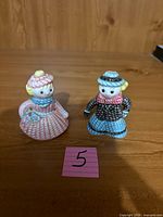 Front view of both ceramic doll figurine shakers