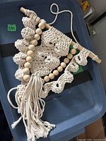 Full view of macramé owl hanging with dowel, beads and fringe