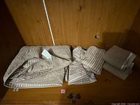 Folded quilted slipcover, smaller quilted covers, striped pillow covers, towels