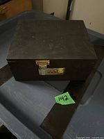 Closed black wood box showing combination latch