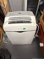 Front view of NOMA portable air conditioner showing louvers and control panel