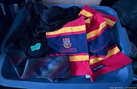 Overall view of sash, cape and tie in storage bin