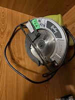 Top view of Ryobi circular saw showing blade guard, front handle and green housing