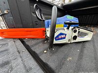 Left side view showing Supmix chainsaw body and orange bar cover