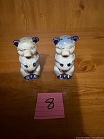 Front view of the two ceramic pig shakers