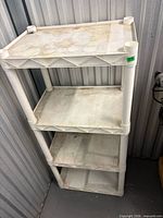 Front angled view of white plastic shelving unit