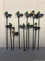 Front view of all ten bar clamps showing varying lengths and color accents