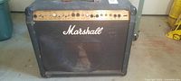 Front view of Marshall Valvestate 8080 showing control panel, torn grille cloth, cabinet wear