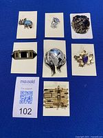 All seven brooches arranged on cards for overview