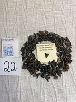 Full collection of fossilized shark teeth arranged in circle with info card