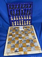 Full view of stone chess board and all pieces in fabric case