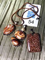 All three sterling silver jasper pendants laid out showing stone patterns, silver settings, and 925 stamp tag