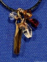 Faceted crystal and tiger-eye style pendant cluster on cord