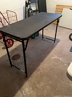 Full view of one black folding table set up