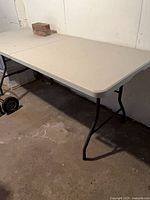 Two folding tables set up in basement
