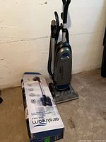 Full view of Airstream upright vacuum beside accessory box